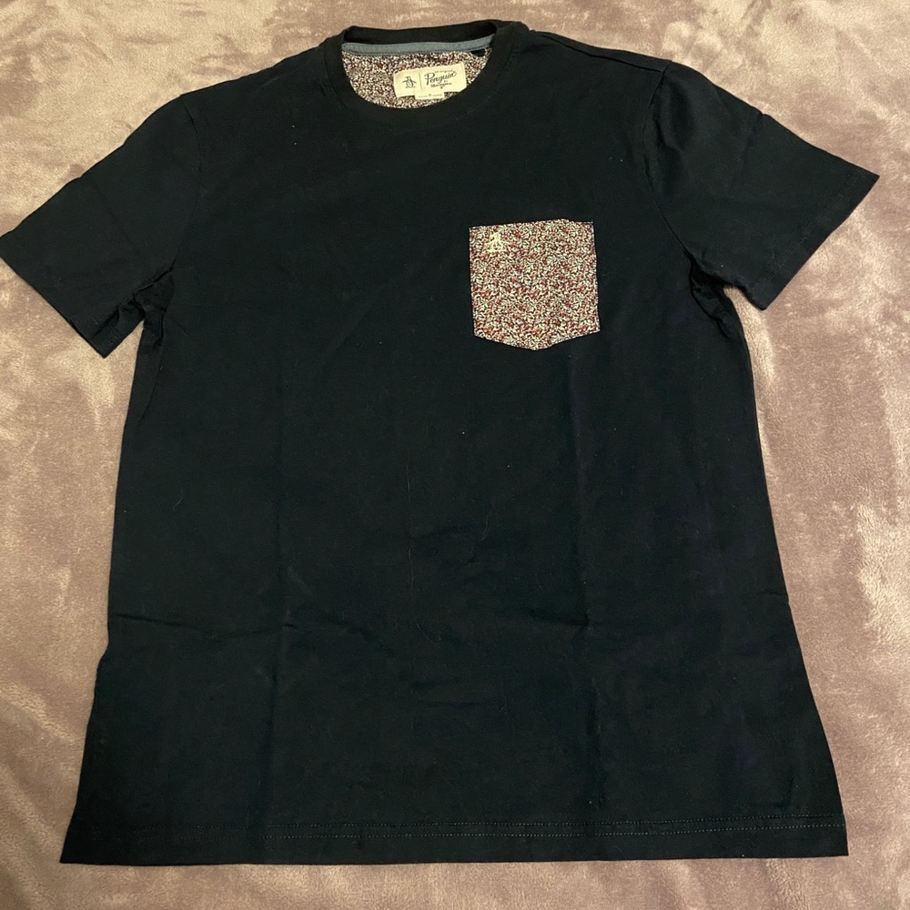 Navy t-shirt with a pocket that has floral designs